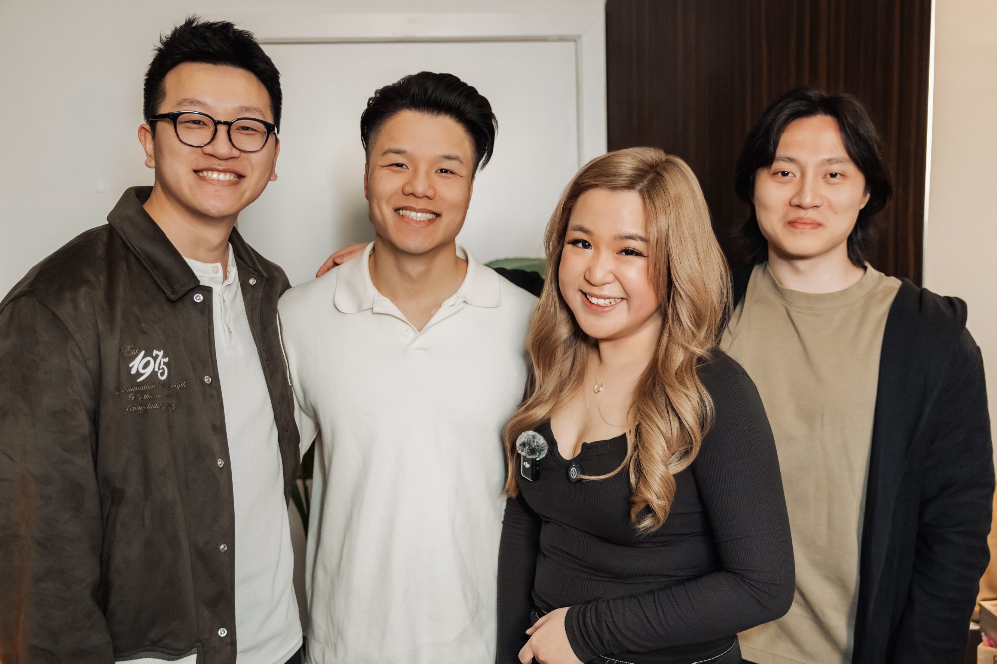 The four Apricity founders standing together, smiling at the camera